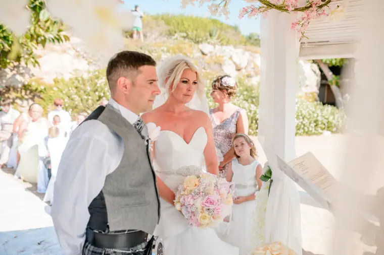 Maryellen and Ben smiling at each other during the ceremony at the gazebo