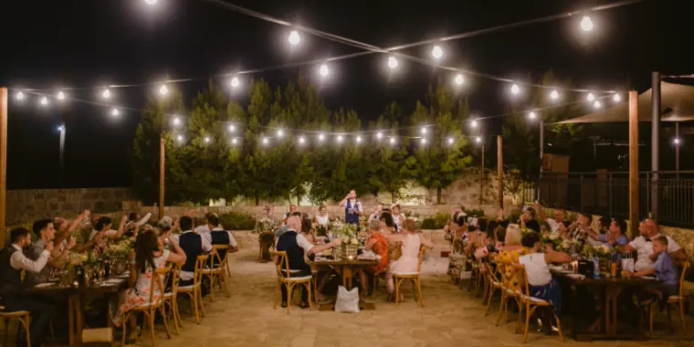 Reception terrace glowing with festoon lights at night at Liopetro, Kouklia