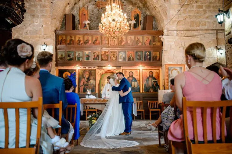 Francesca and Stephen sharing their first kiss before the icon screen at Ayia Kyriaki