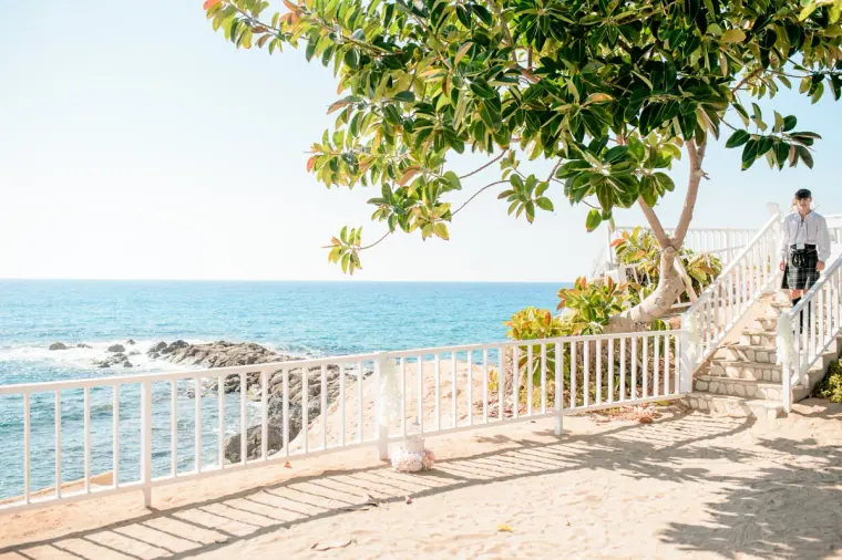 Sandy terrace and white railings overlooking the sea at Laura Beach Hotel, Paphos