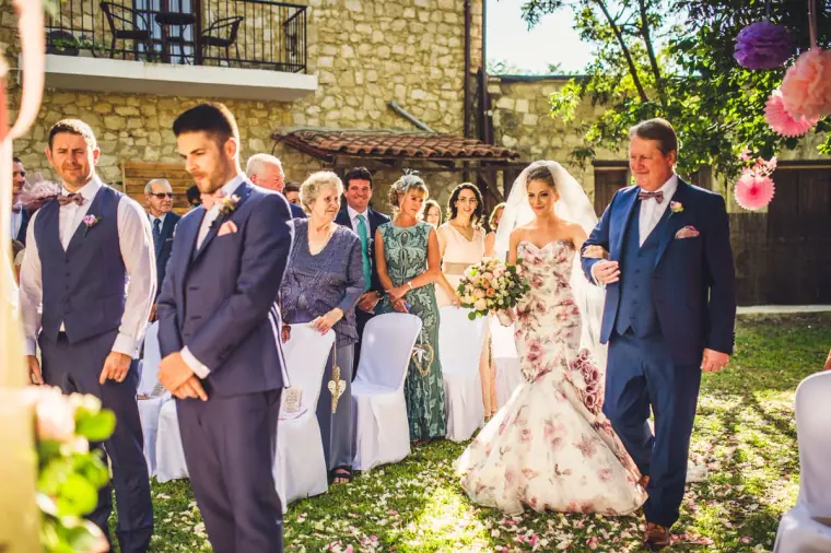 Bride in a floral mermaid gown walked down the aisle towards the groom