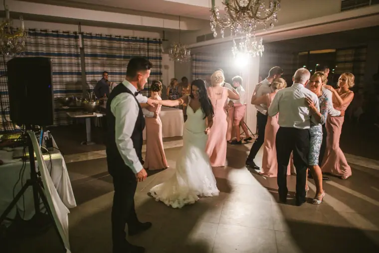 Jaclyn and Steven dancing with guests and bridesmaids in pink on the dancefloor