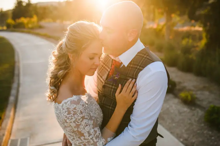 Ramune and Derek embracing on a sunlit road at Secret Valley, Paphos