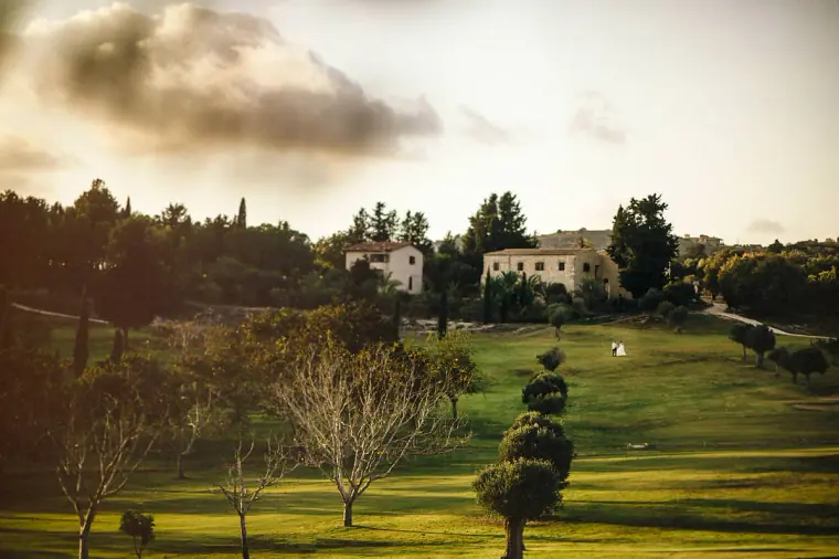 Golf course greens and stone villas bathed in evening light at Minthis Hills