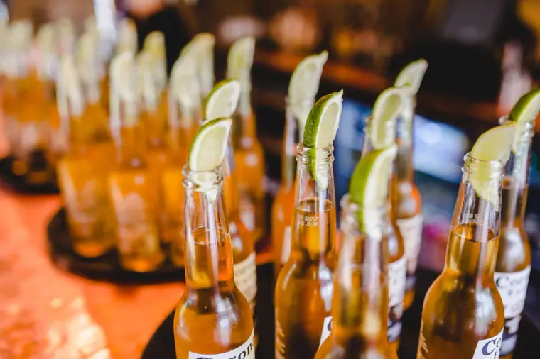 Rows of Corona beer bottles topped with lime wedges
