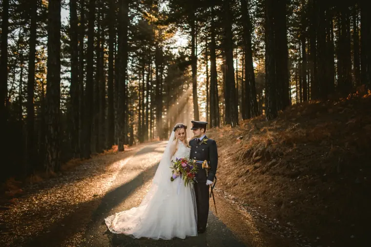 Steph and Alasdair on a forest track as sun rays pour through pines, Troodos