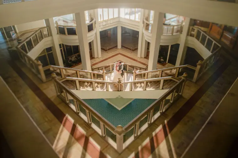 Looking down through the hotel atrium to the couple on a lower balcony