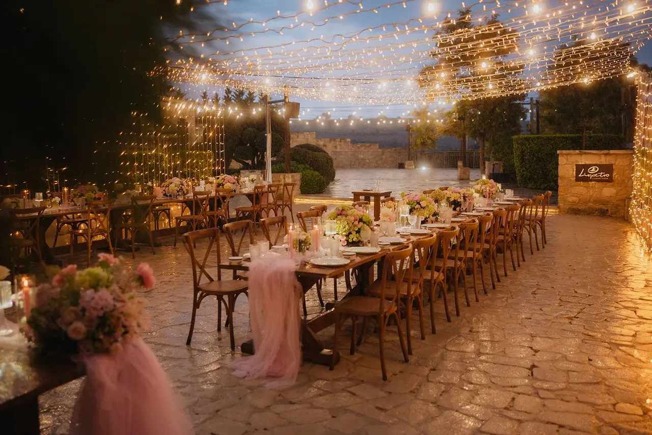 Long reception tables under a canopy of fairy lights at Liopetro