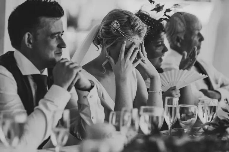 Black-and-white photo of the top table laughing during the speeches