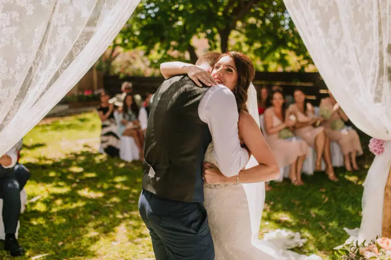Sean and Claire hugging after the ceremony as guests look on