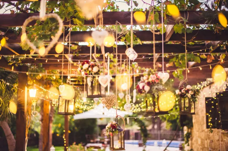Hanging lanterns, hearts and string lights over the courtyard at dusk