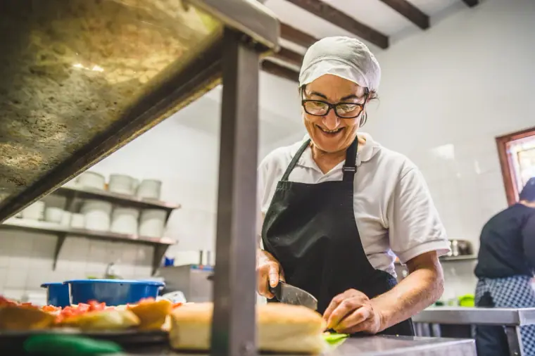 Smiling chef preparing food in the inn's kitchen