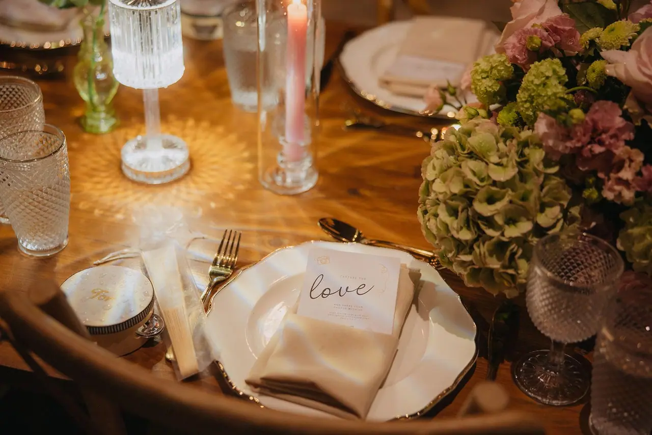 Place setting with a handwritten 'love' card and crystal glassware
