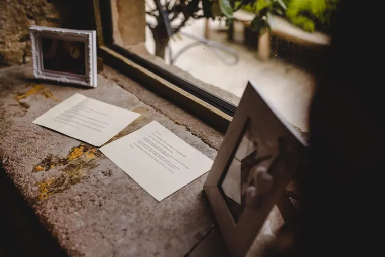 Framed notes and cards on a stone windowsill