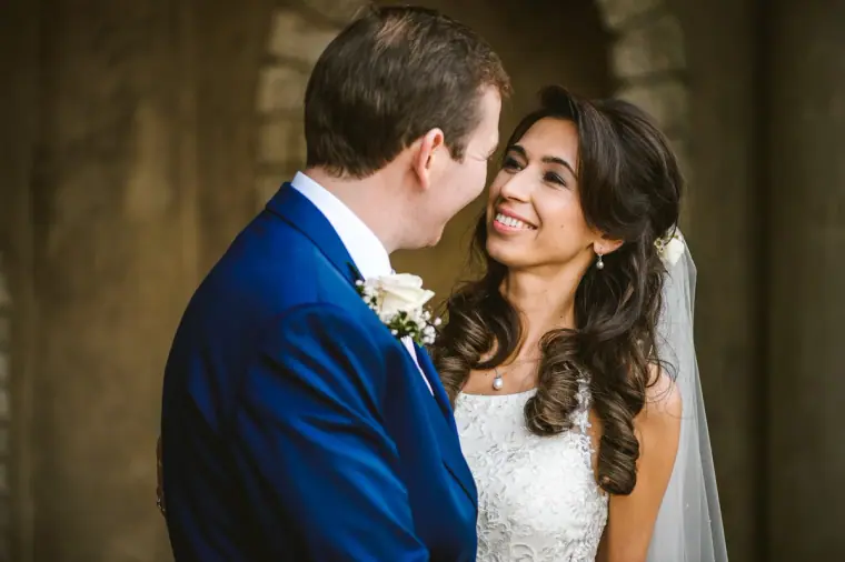 Close portrait of Elina and Iain smiling at each other