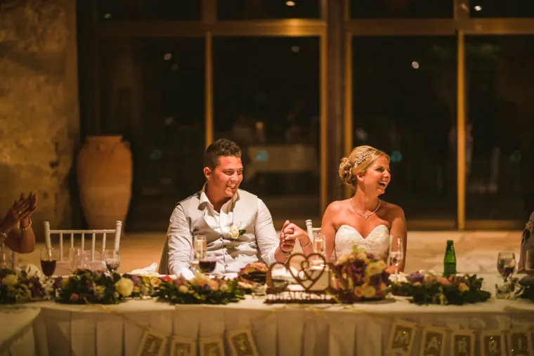 Charlotte and Nathan laughing at the top table during the speeches