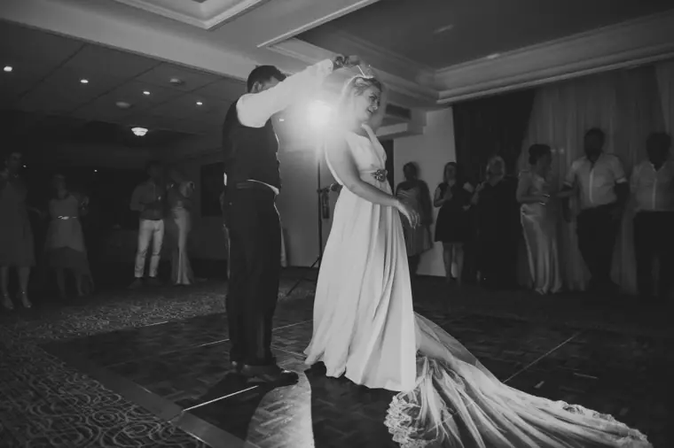 Black-and-white photo of the couple's first dance with her long train