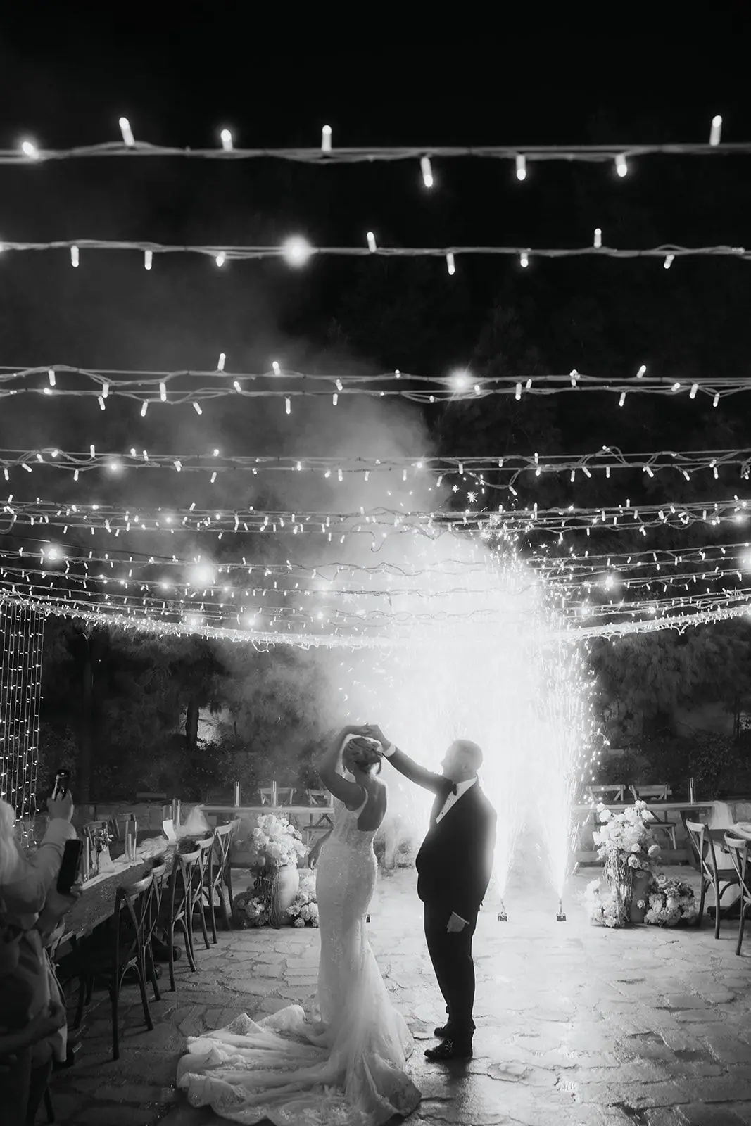 Black-and-white photo of Oliver spinning Zoe during their first dance