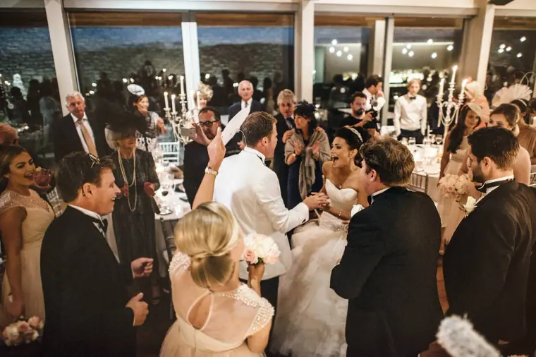 Packed dance floor with the bride and groom celebrating among their guests