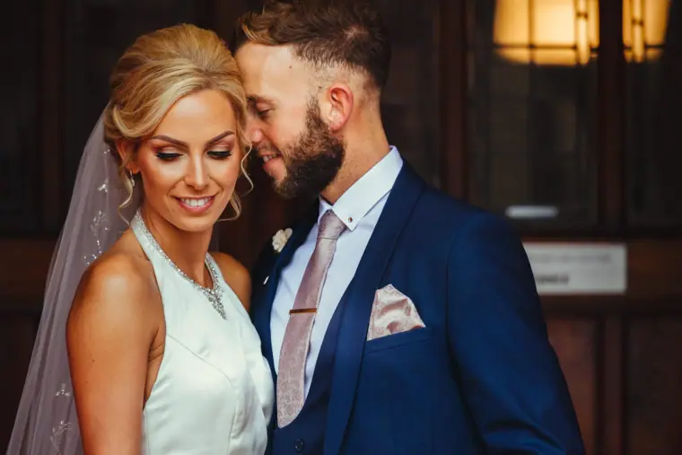 Bride and groom touching foreheads, softly smiling