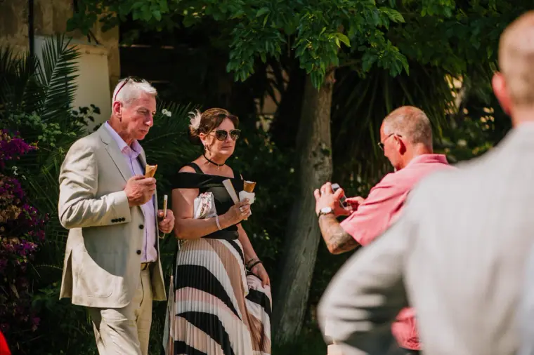 Guests chatting and enjoying ice creams in the sunny garden