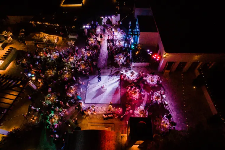 Aerial view of a night-time reception lit in pink and purple at Anassa, Cyprus