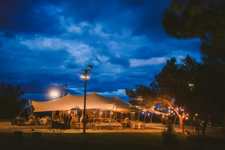 Stretch tent glowing beneath a deep blue evening sky at Lexeko Estate, Cyprus