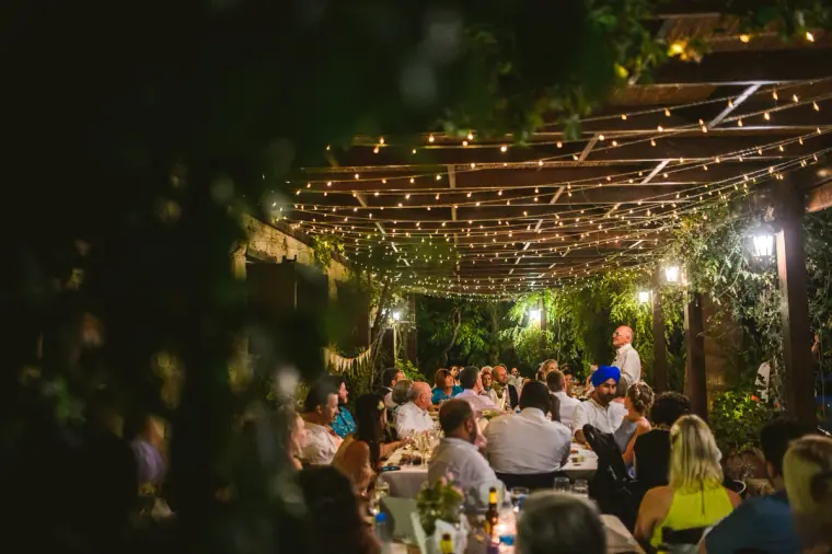 Guests dining under a pergola strung with fairy lights at Vasilias Nikoklis Inn