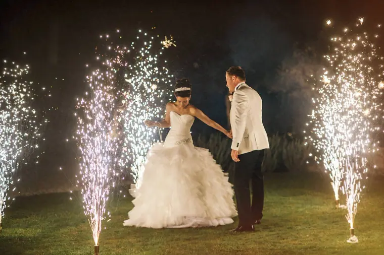 Katie and Paul's first dance on the lawn between cold sparkler fountains at night
