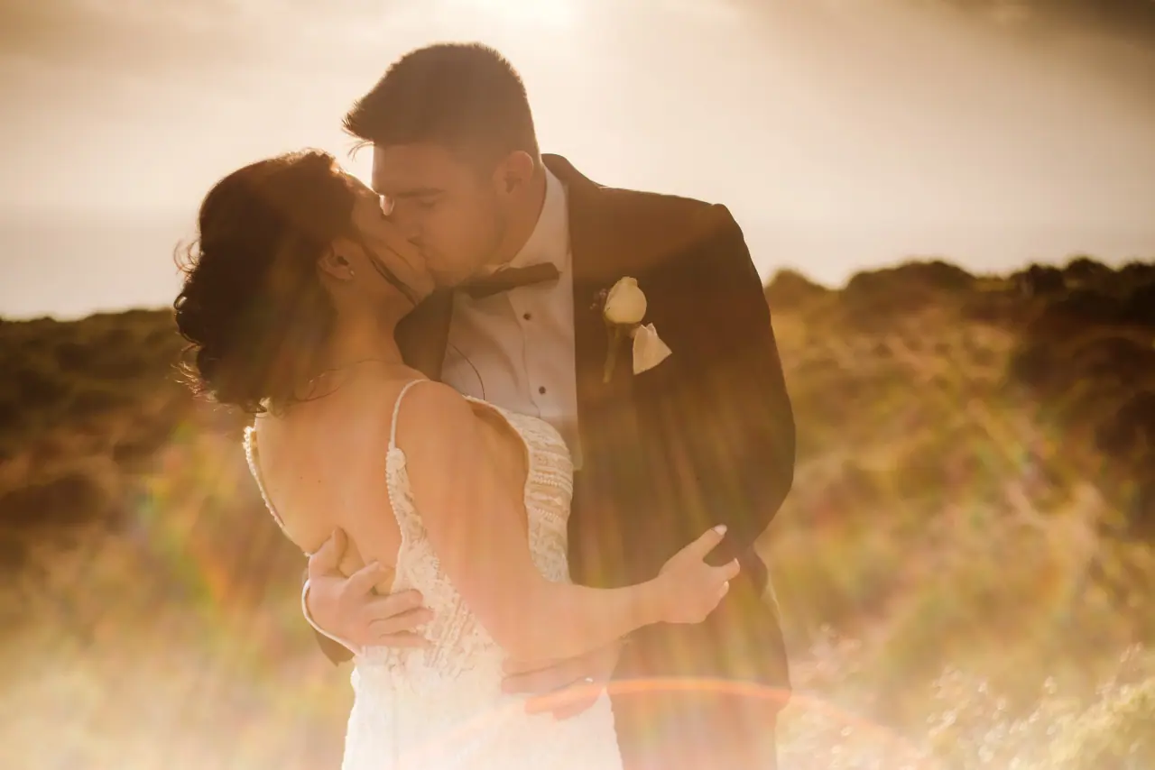 Catherine and Sean kissing in warm golden backlight at Aphrodite Hills
