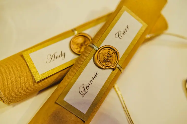 Gold place cards for Andy and Leonnie sealed with wax