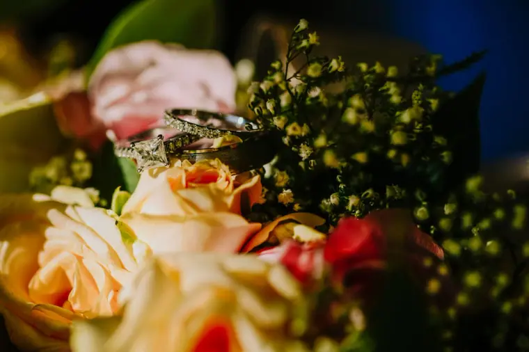 Close-up of peach roses and red berries in the bridal bouquet