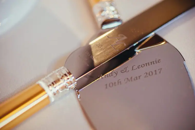 Engraved cake knife reading "Andy & Leonnie, 10th Mar 2017"