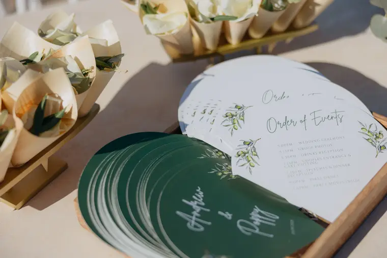 Petal cones and green order-of-events fans printed with the couple's names