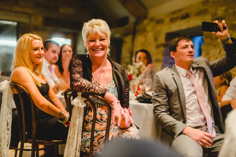 Guests laughing at their table during the reception