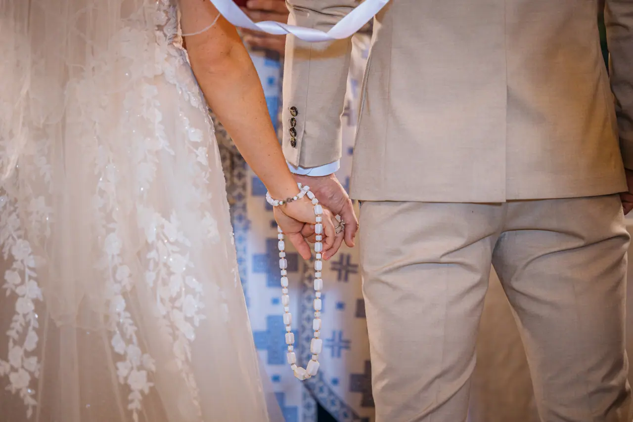 Close-up of the couple's joined hands during a Greek Orthodox ceremony, Liopetro