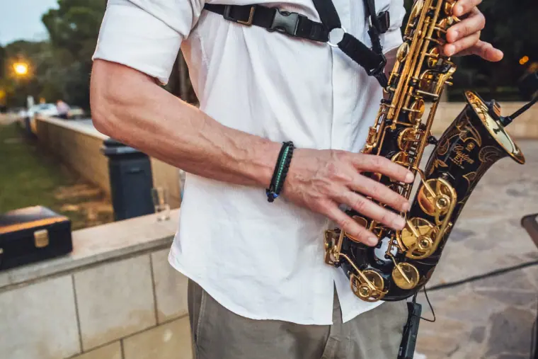 Close-up of a saxophonist's hands on a gold saxophone during the reception