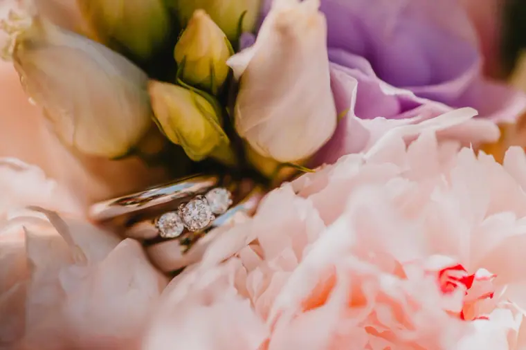 Wedding rings nestled in soft pink peony petals, Vasilias Nikoklis Inn