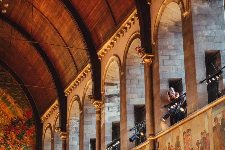 Mural-painted arches and gallery inside Mansfield Traquair