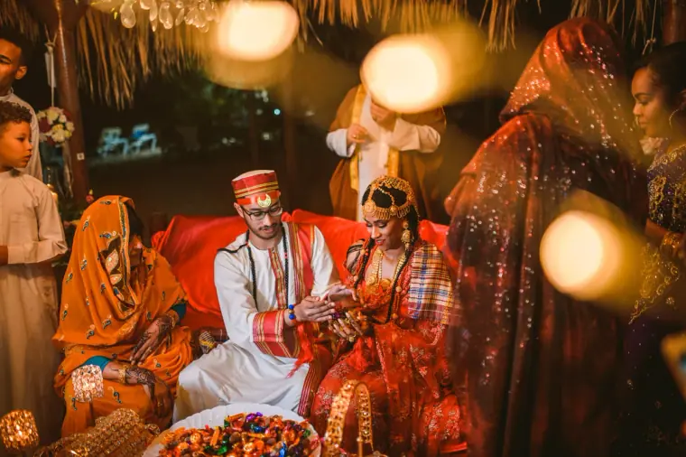 Raya and Adhib seated among family during their Indian wedding ceremony, Ayia Napa