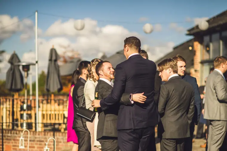Charlie hugging a guest during the drinks reception by the barns