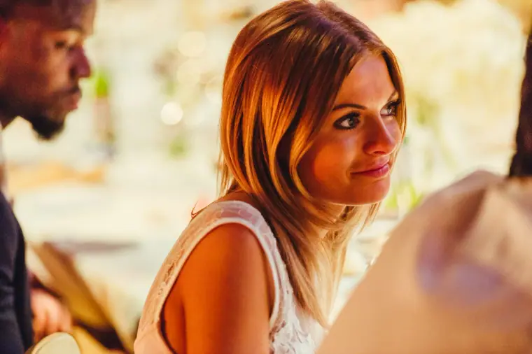 Guest smiling softly as she listens to the speeches