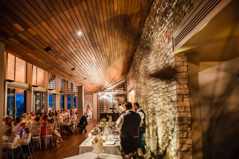 Long view of the candlelit dining room during the reception at Minthis Hills