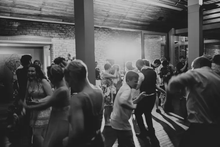 Black-and-white photo of guests crowding the dance floor