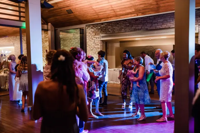 Guests dancing under coloured lights in the Minthis Hills restaurant