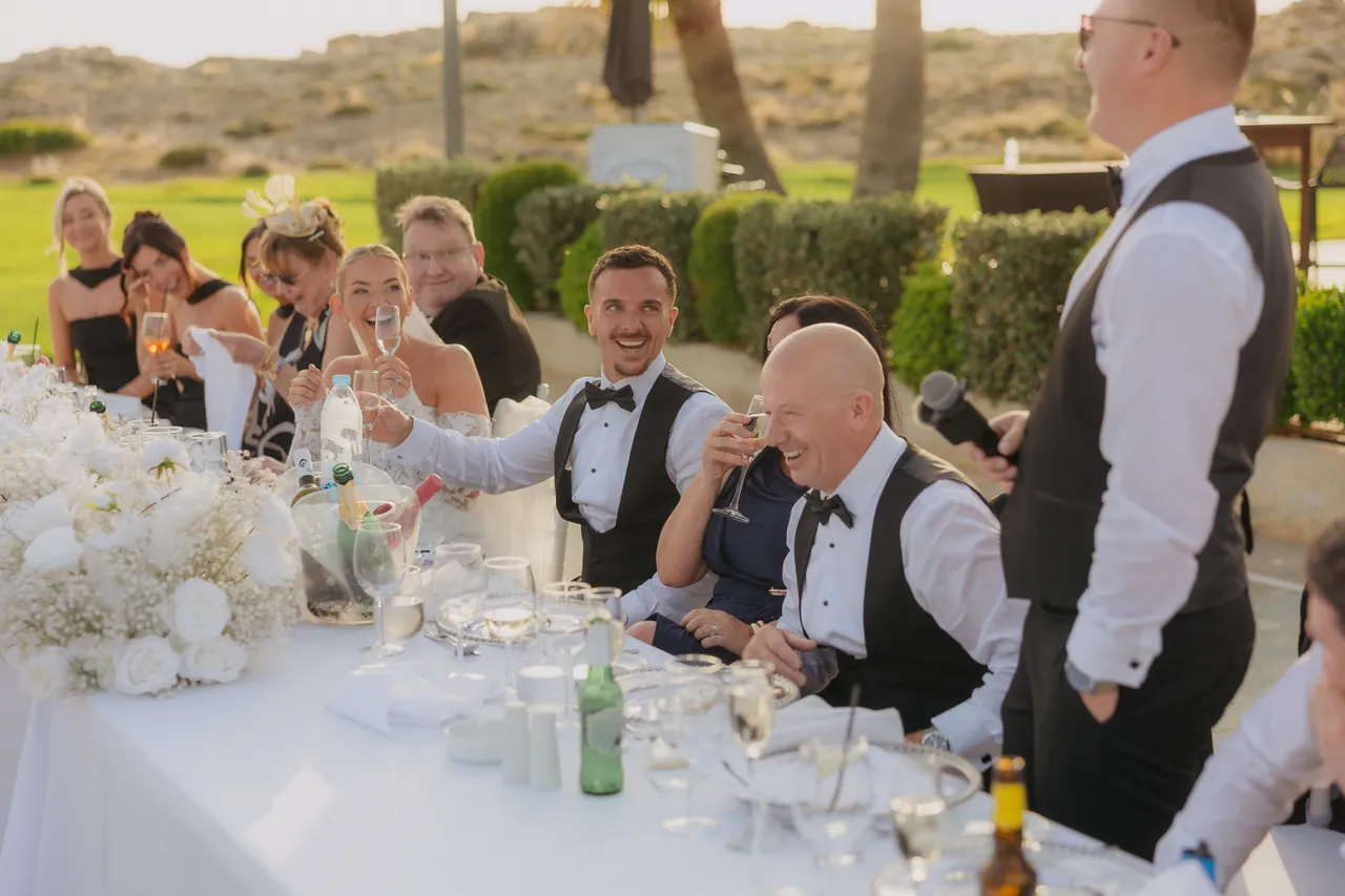 Guests laughing at the top table during the speeches