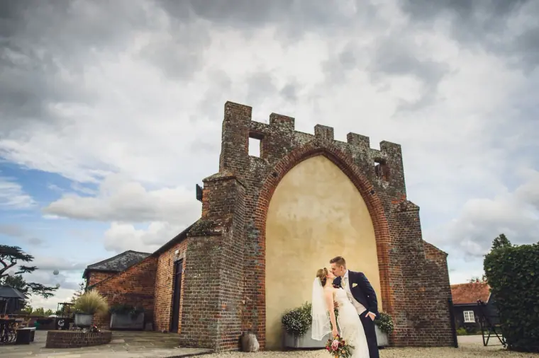 Sarah and Charlie beneath the ruined Gothic brick arch at Wasing Park