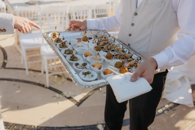 Waiter serving a tray of canapés during the cocktail hour