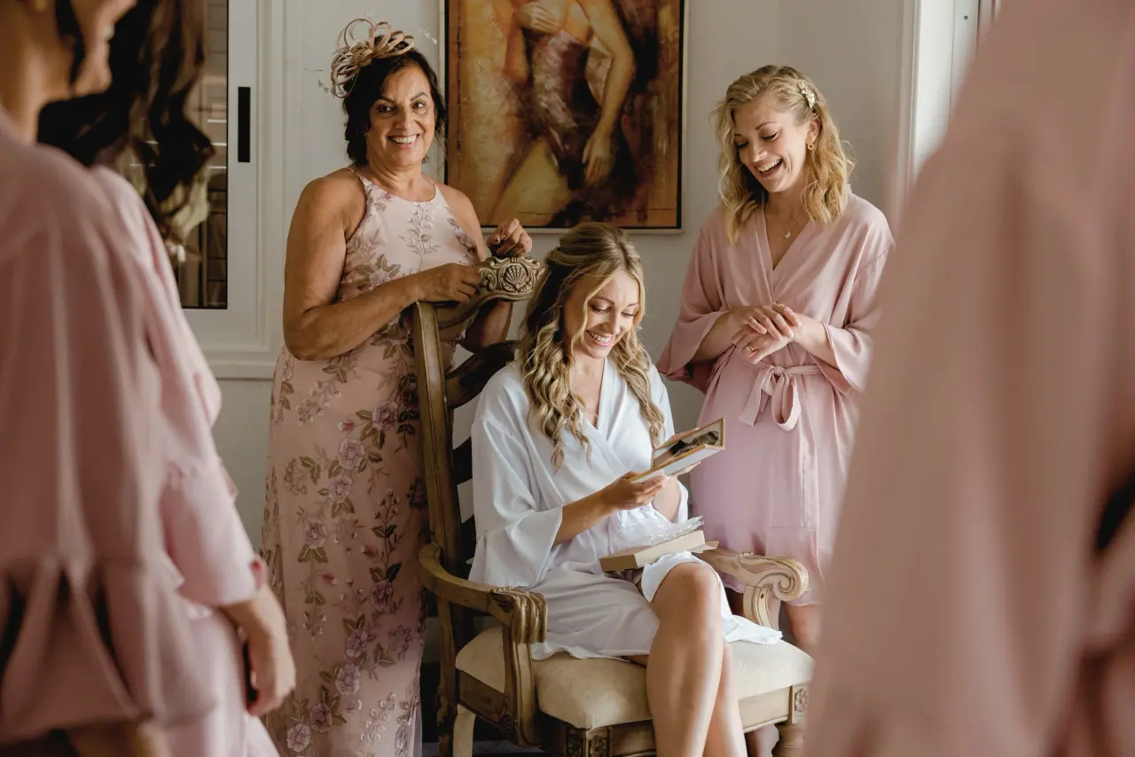 Becky in a white robe getting ready with family in pink, Coral Residence
