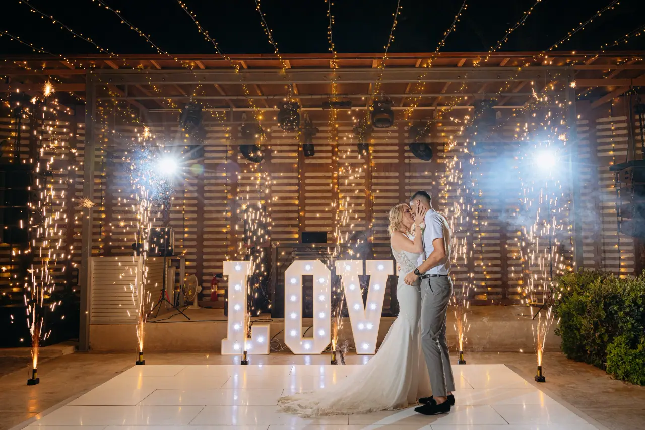 Beth and Alex's first dance between sparkler fountains and giant LOVE letters at Alassos